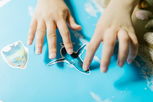 child creating collage